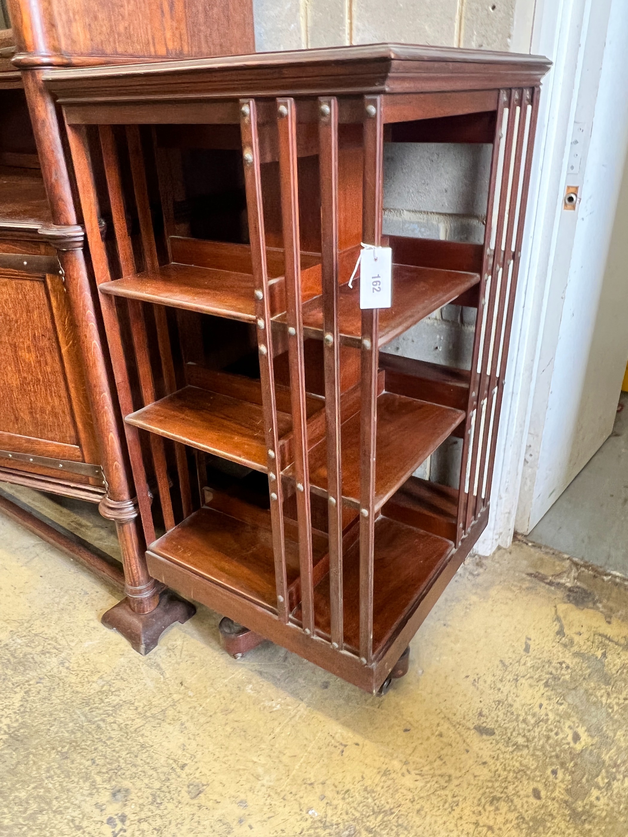 An Edwardian walnut revolving bookcase, width 60cm, height 120cm